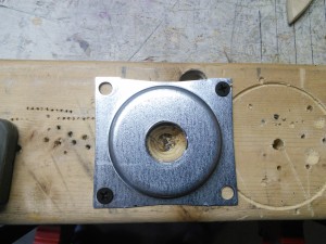I sometimes have good ideas. Like bolting this piece down to a scrap piece of 2x4 to drill it for a cable connector.